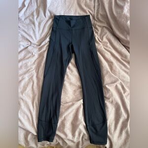 Black Lululemon leggings with pocket in the back of the waistband.